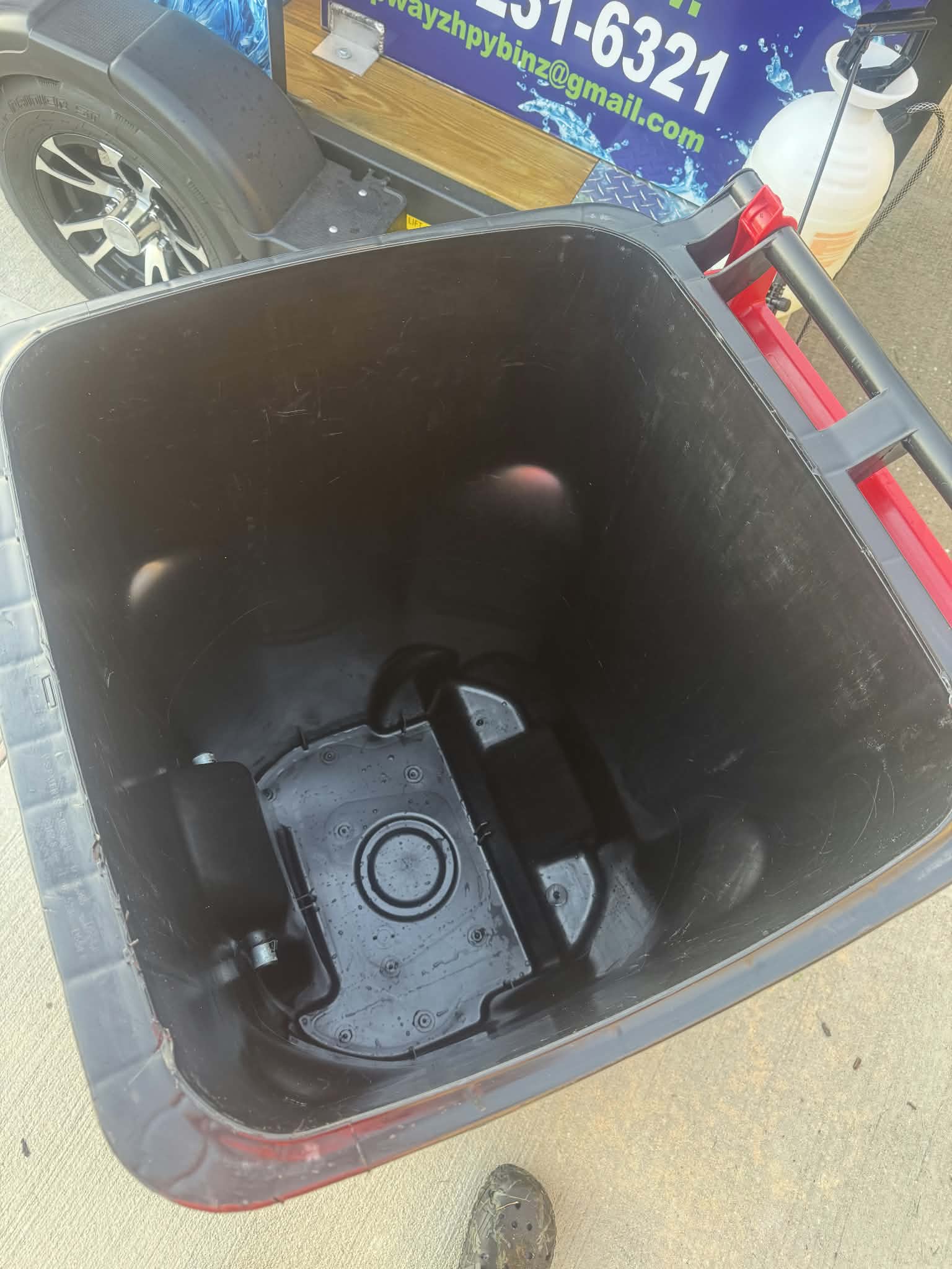 Inside of the same trash bin after cleaning, with the walls and bottom washed clean